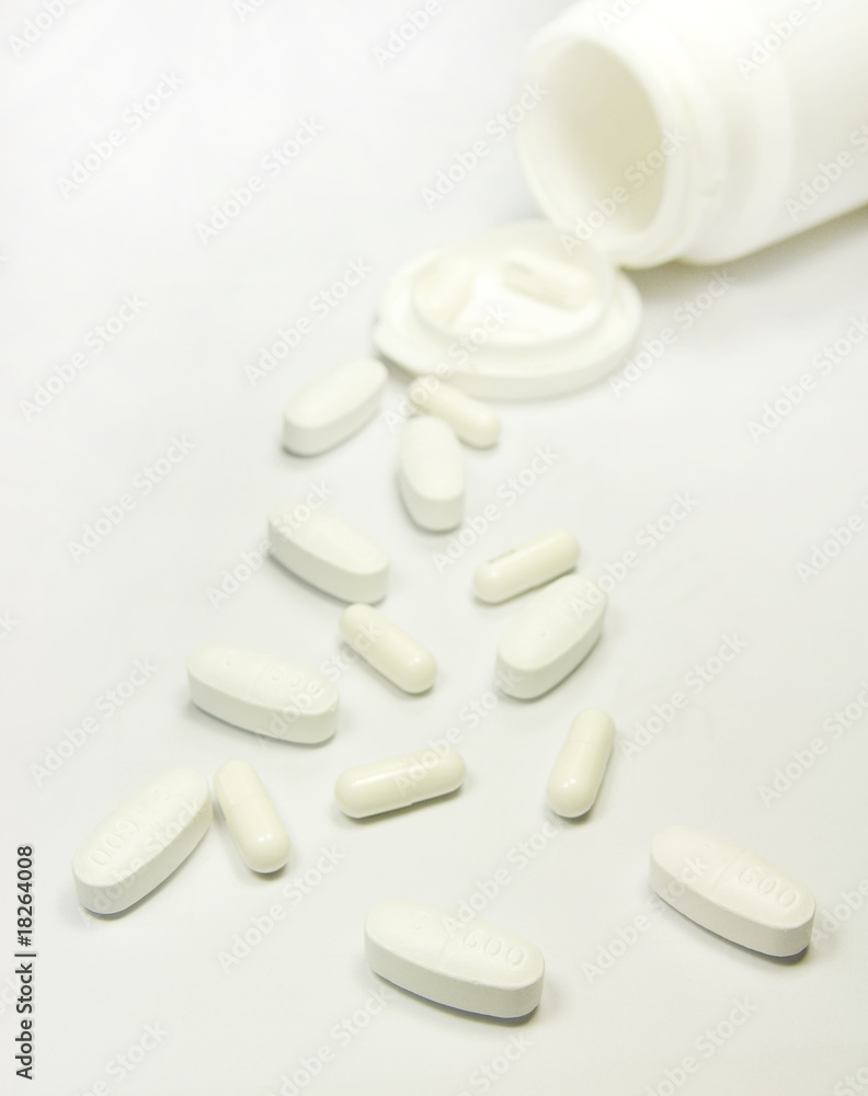 White drug pill and capsule on white table White drug pill and capsule on white table