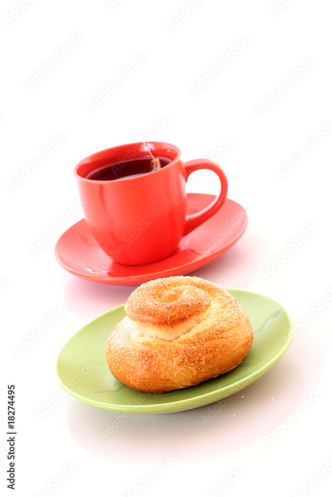Buns and cup of tea on white Buns and cup of tea on white