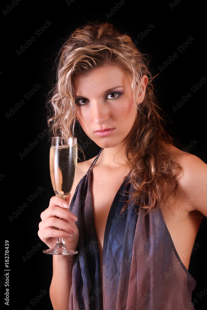 Beautiful woman with a glass of champagne on black background