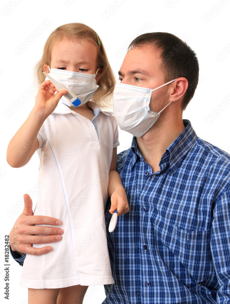 Family in medical masks with a thermometer.