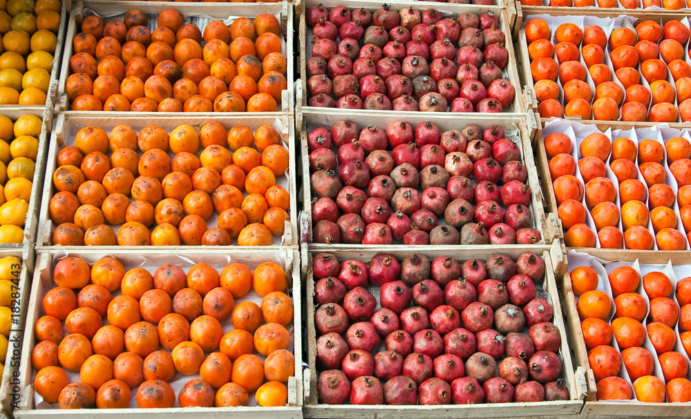 Persimmons and garnets in boxes