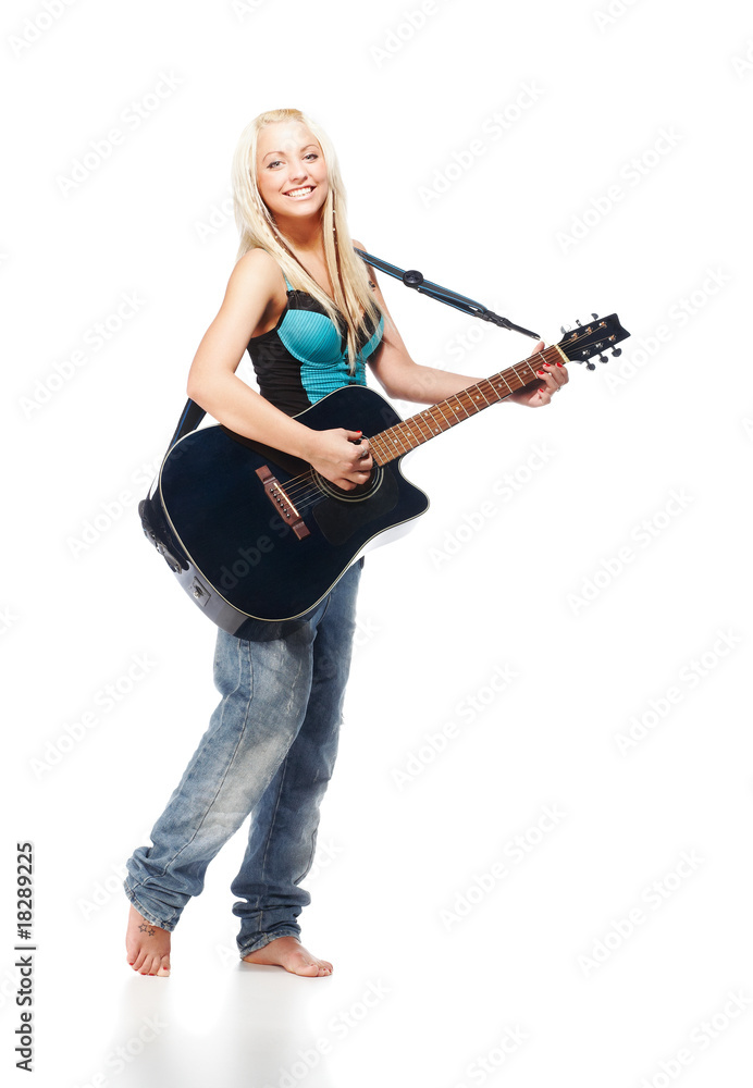 Teenage girl playing an acoustic guitar wearing jeans on white Teenage girl playing an acoustic guitar wearing jeans on white