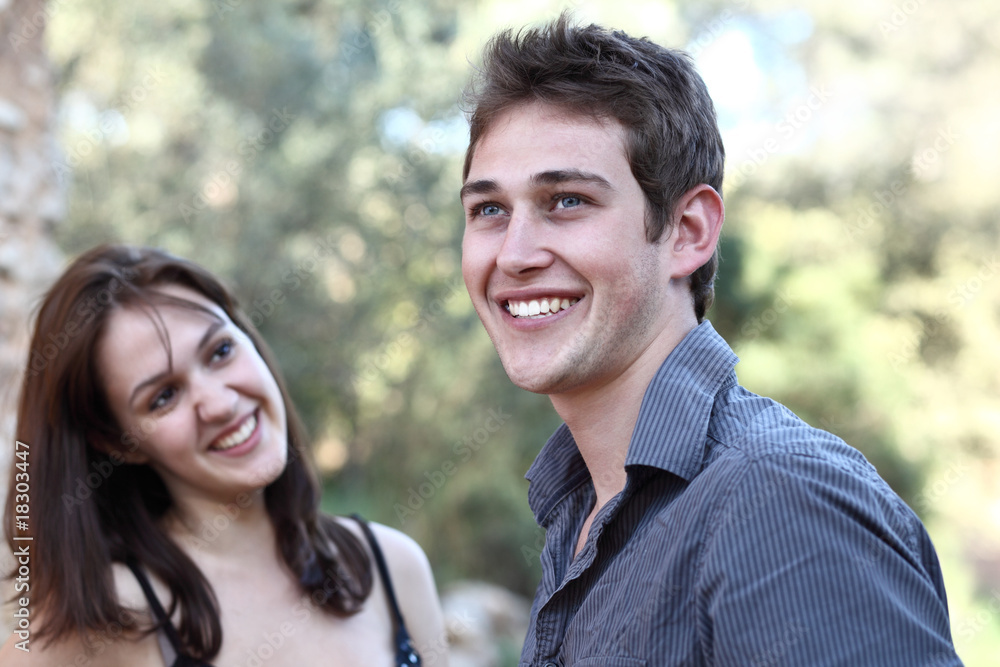 Beautiful young couple outdoors - smiling having fun. Beautiful young couple outdoors - smiling having fun.