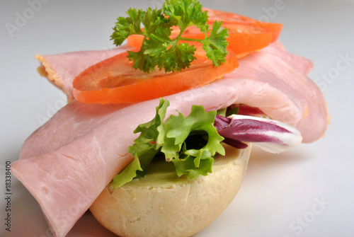 bread roll with ham and organic tomato