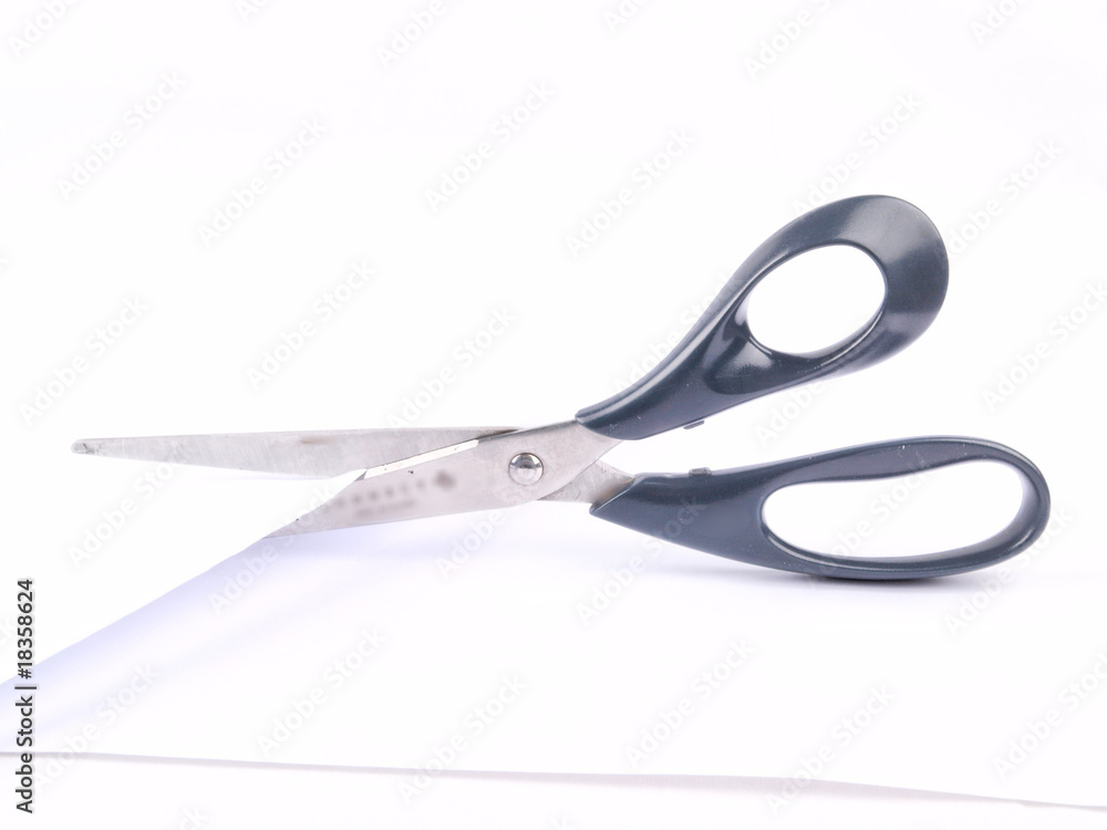 Pair of scissors cutting paper, black handle Pair of scissors cutting paper, black handle