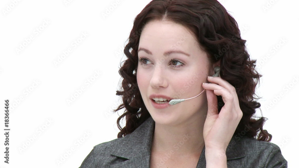 Young female employee on a headset Young female employee on a headset