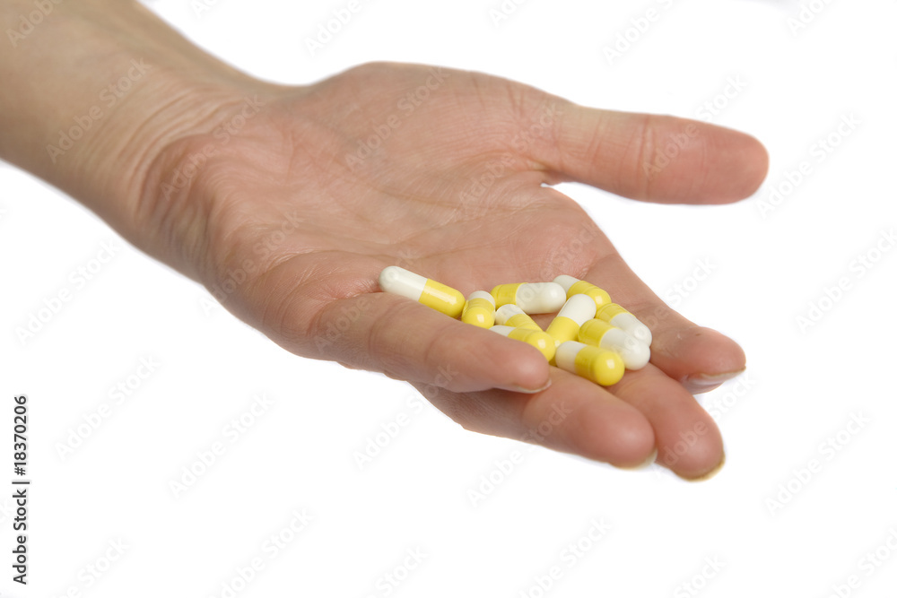 hand with pills on white hand with pills on white