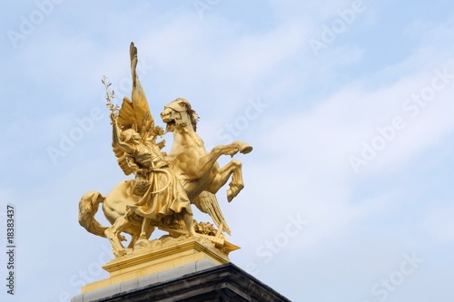 gold statue from alexandre III bridge in paris