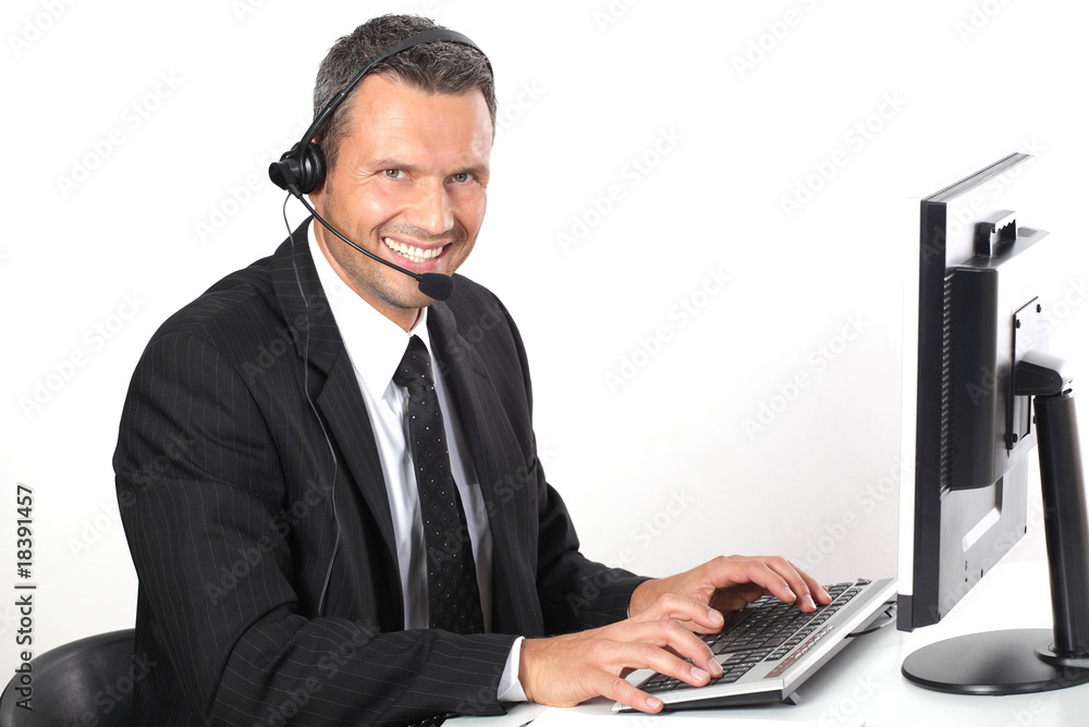 Mann mit Headset am Schreibtisch Mann mit Headset am Schreibtisch