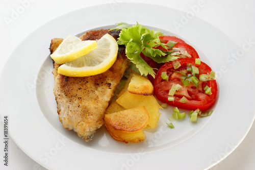 grilled carp fillet with organic vegetable on a plate