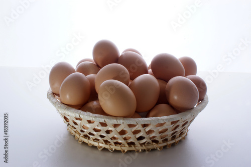 some fresh organic eggs in a hand made basket