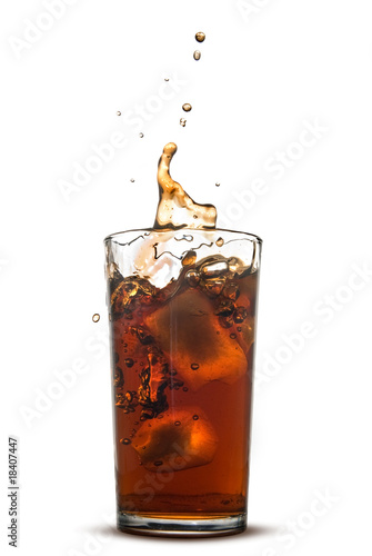 Beautiful splash of cola in glass isolated on white