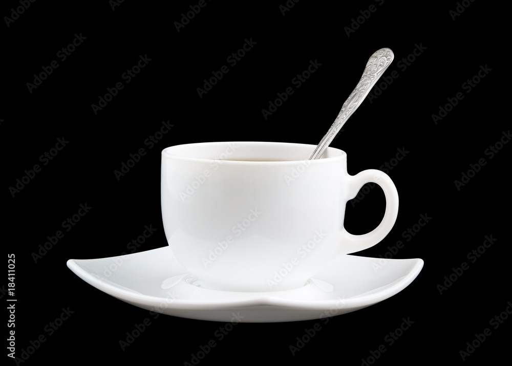 White cup of fresh tea with spoon and saucer isolated on black White cup of fresh tea with spoon and saucer isolated on black