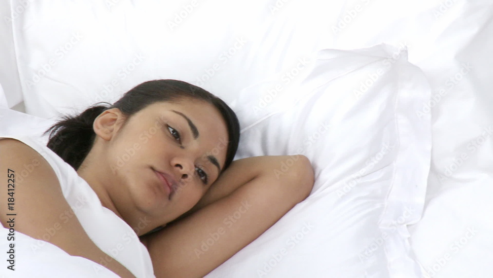 Close-up of upset woman lying in bed with a man Close-up of upset woman lying in bed with a man