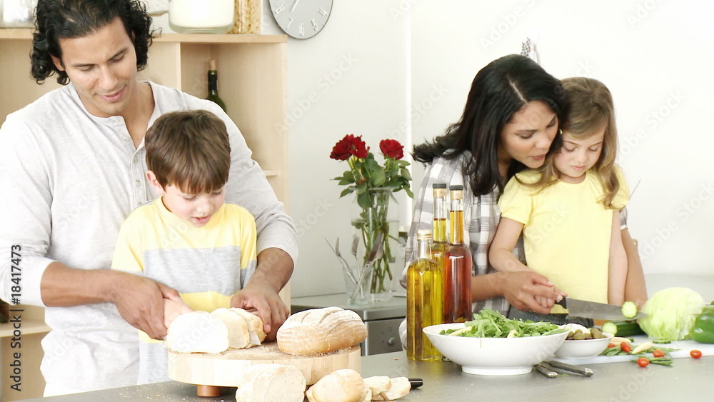 Happy family preparing a meal in the kitchen Happy family preparing a meal in the kitchen