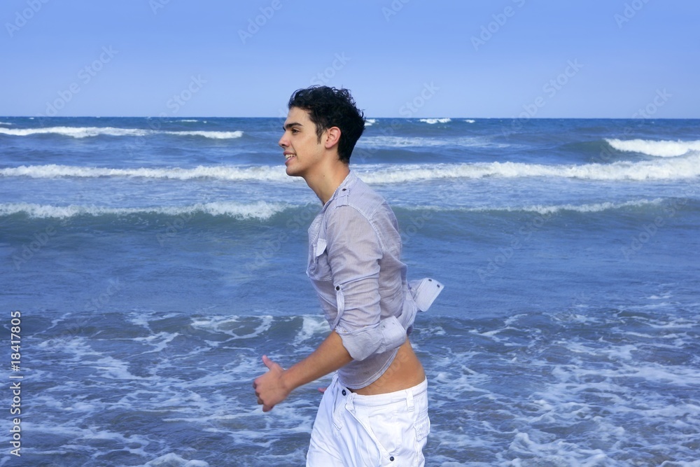 Handsome young man on the blue ocean beach Handsome young man on the blue ocean beach