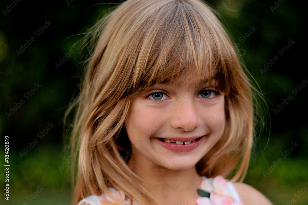 Cute child close up with blurred green background Cute child close up with blurred green background