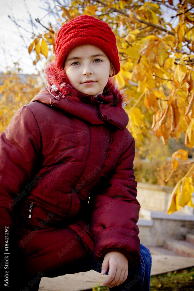 Girl with red hat at autumn
