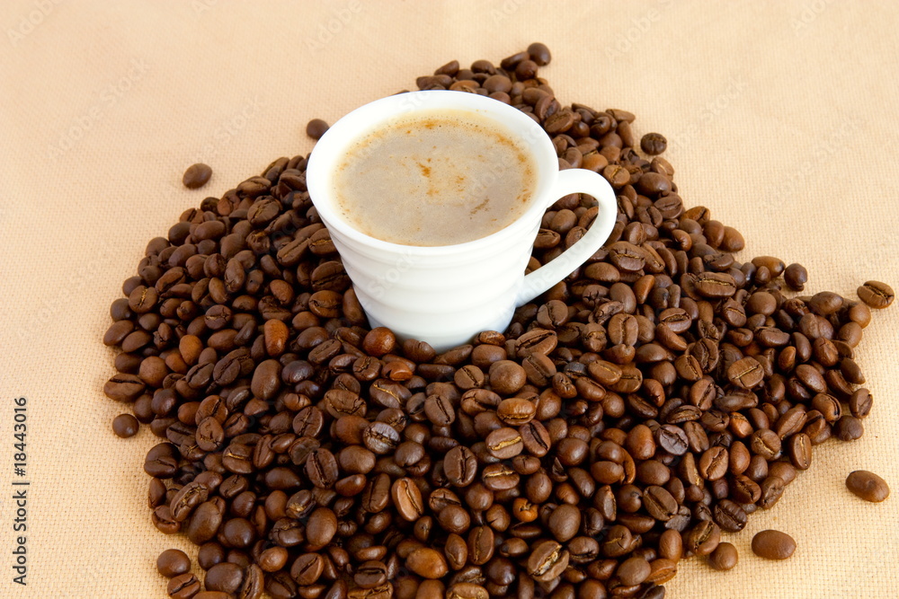 Cup with coffee, costing on coffee grain Cup with coffee, costing on coffee grain