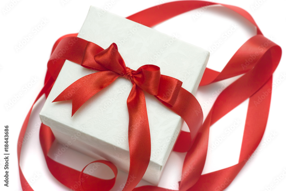 white gift box with a red ribbon and bow isolated over white white gift box with a red ribbon and bow isolated over white