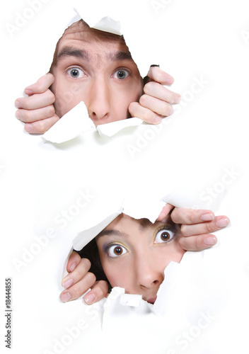 couple peeping through hole in white paper photo