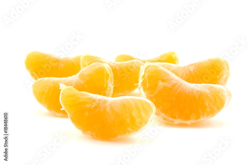 slices of mandarin over white background