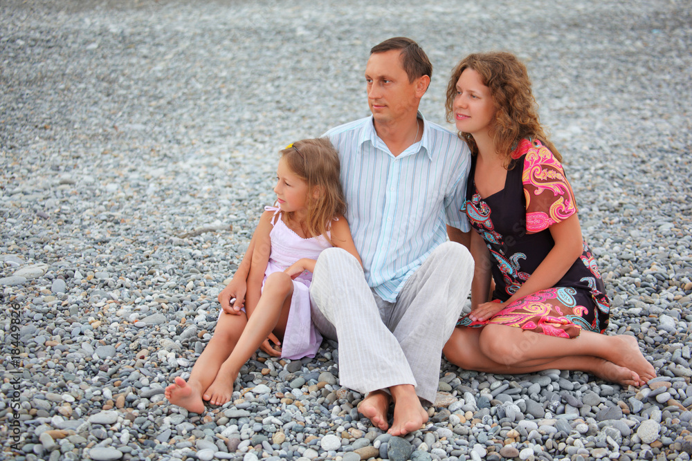 Happy family on stone beach, summer Happy family on stone beach, summer