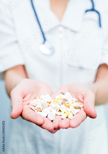 Doctor holding pills