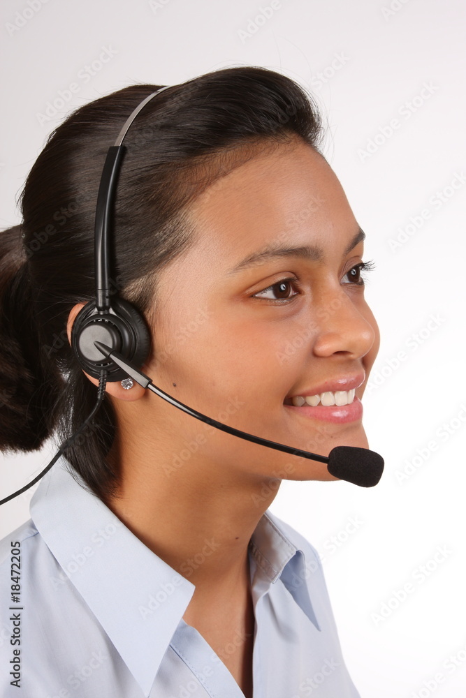 Telephone support being provided by beautiful young woman Telephone support being provided by beautiful young woman