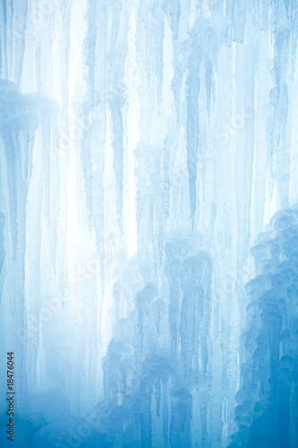 A frozen waterfall with ice in a blue and white color in winter