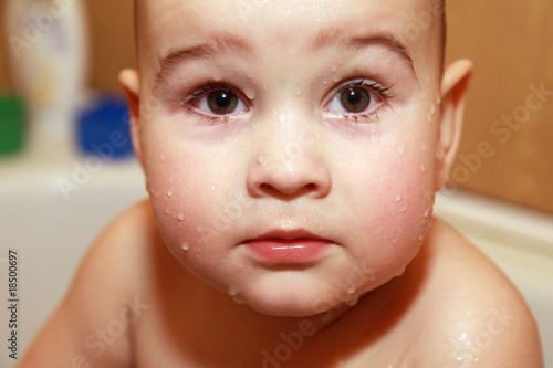 Close-up face baby with drops in bathroom