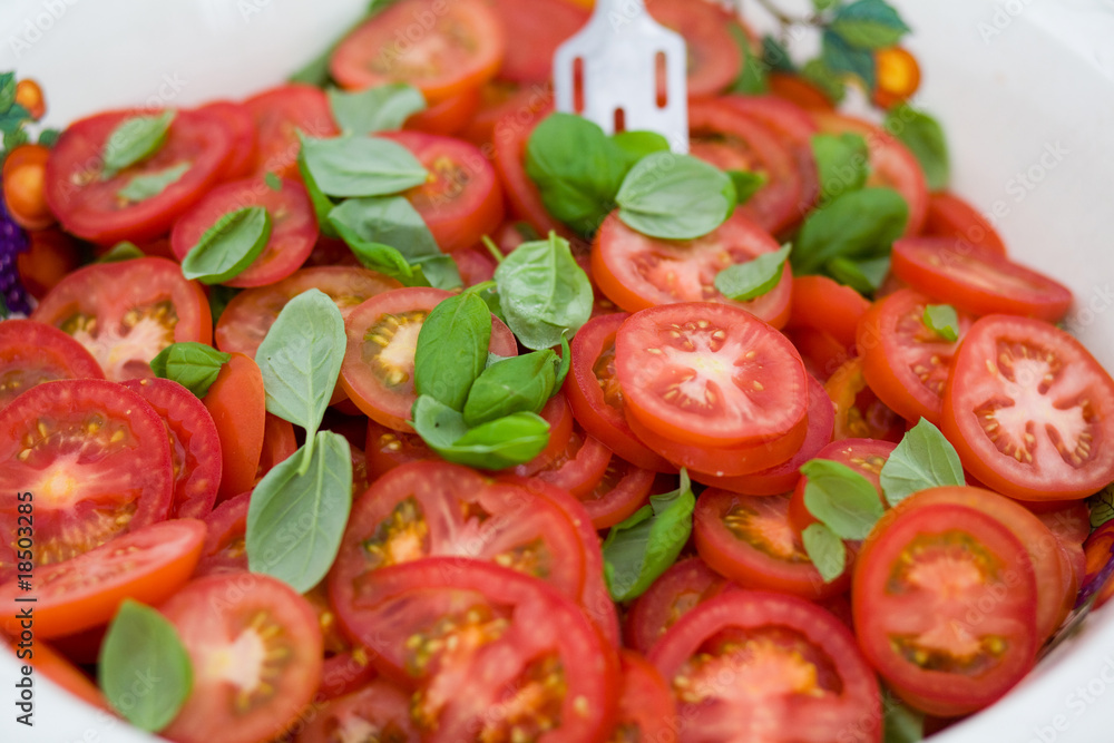 tomatoes and basil in a bowl at a catered event tomatoes and basil in a bowl at a catered event