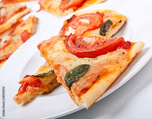 sliced cheese and tomato pizza
