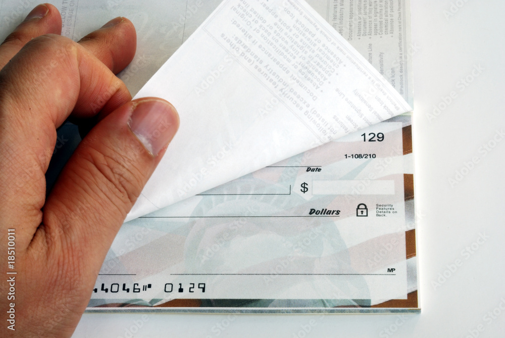Фотография Flip the checkbook on white background.