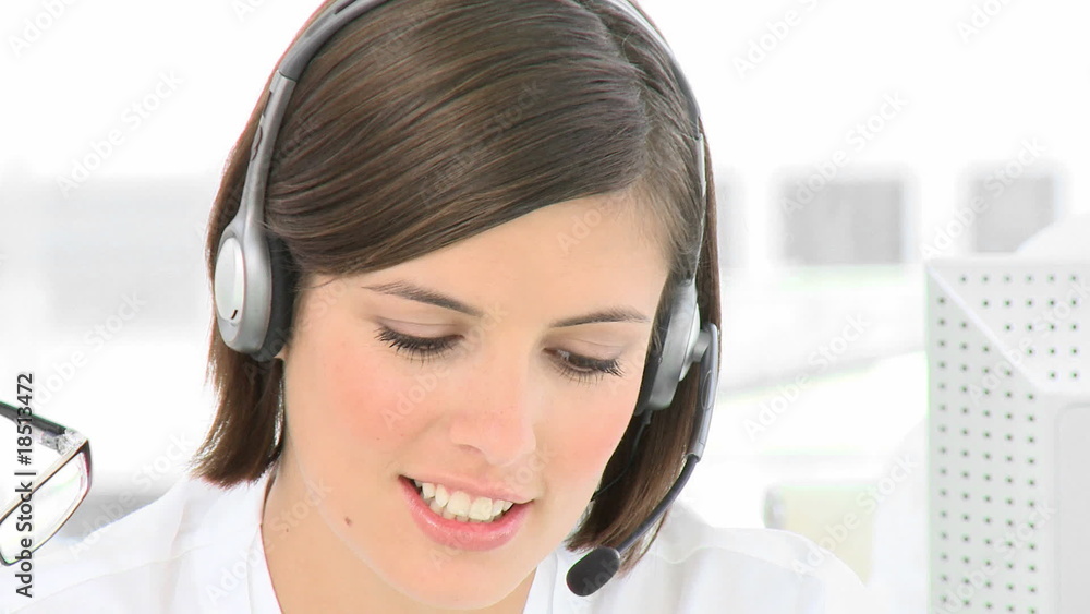 Businesswoman talking on a headset in the office Businesswoman talking on a headset in the office