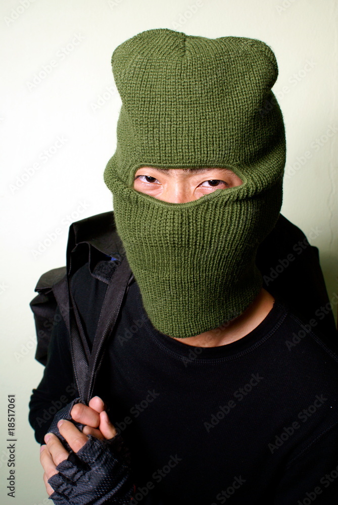 Smiling cat burglar with balaclava mask