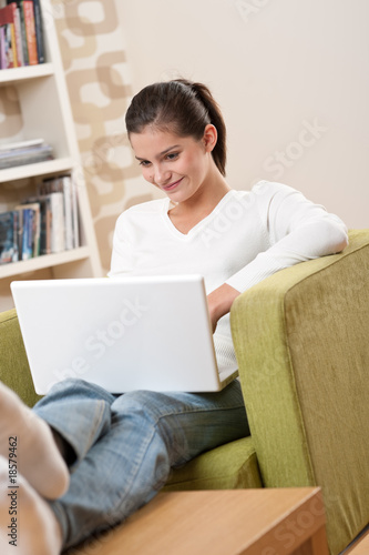 Students - Happy teenager with laptop in modern lounge