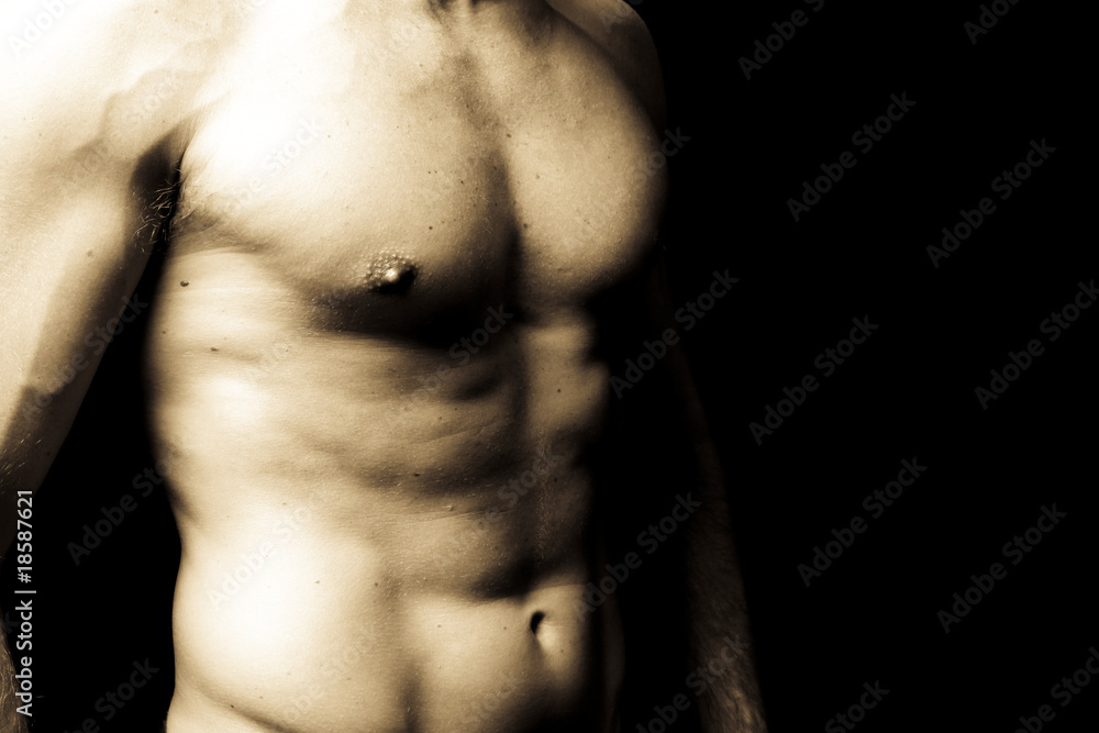 muscular male torso on black background