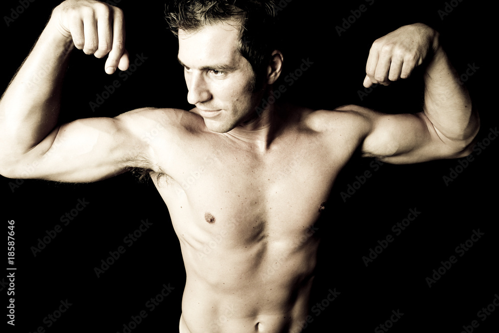 portrait of sexy muscular man showing his biceps