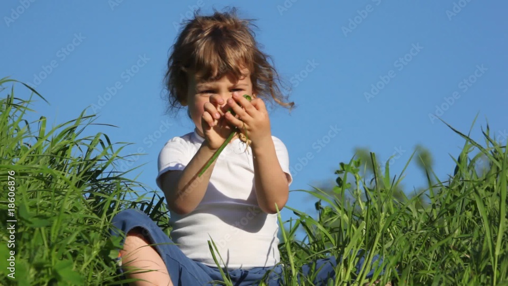 girl playing with grass and smiling girl playing with grass and smiling