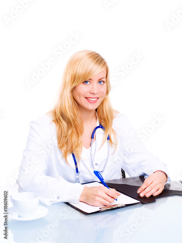 smiling female doctor with stethoscope sitting in office