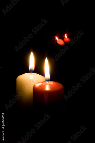 Red and yellow candles on black background