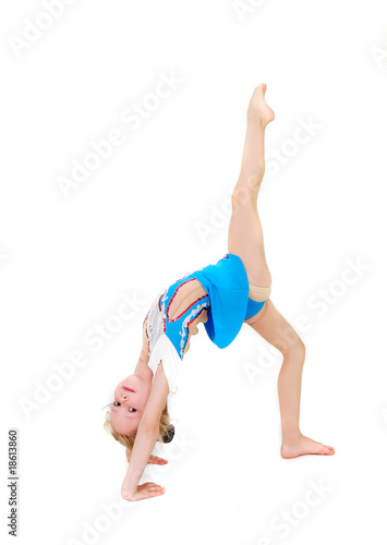 young girl doing gymnastics over white