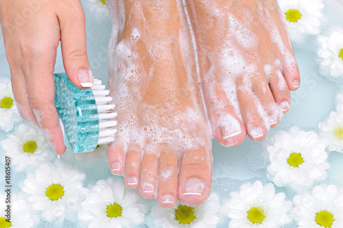 Woman washes and cleans her foot photo