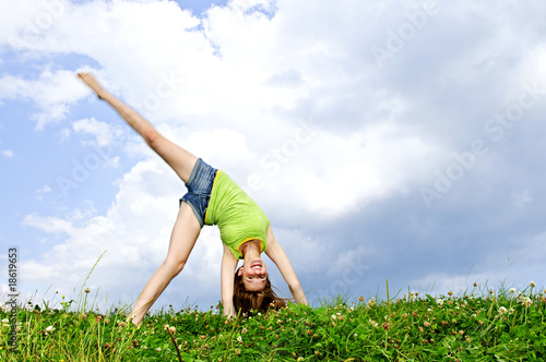 Young girl doing cartwheel photo