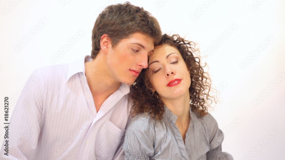 Couple on white background looking at each other and laughing Couple on white background looking at each other and laughing