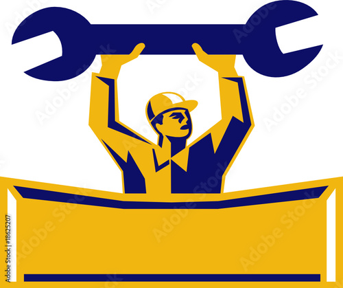 automobile mechanic holding up a spanner