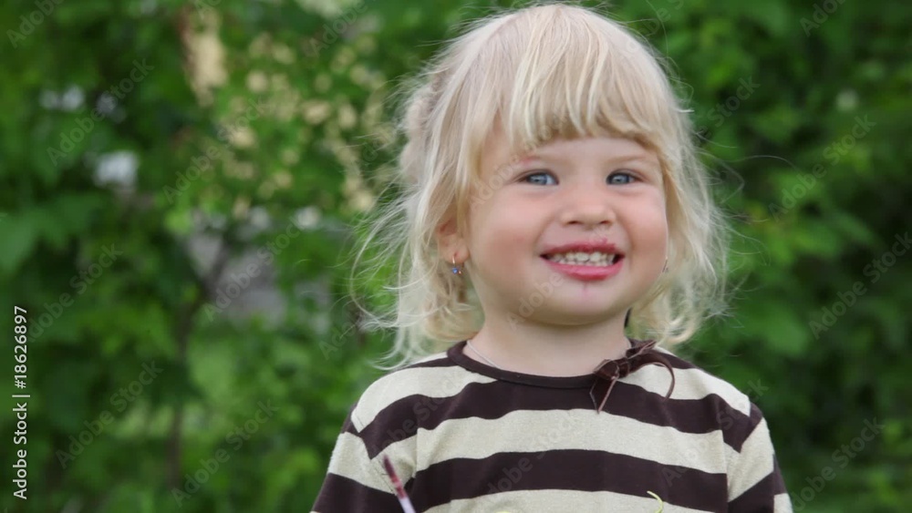 little girl applying make up and smiling little girl applying make up and smiling