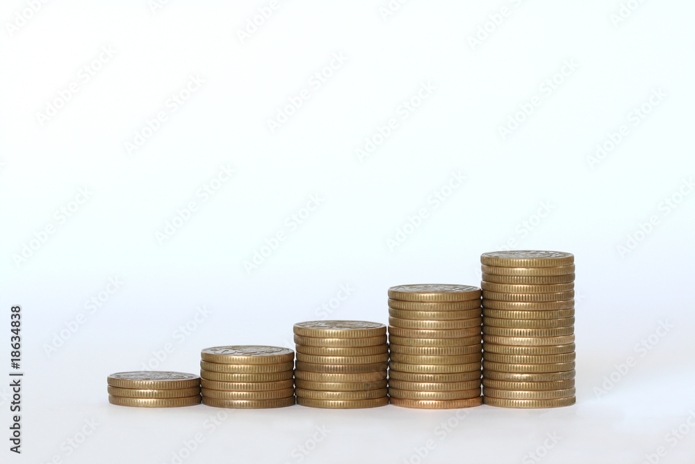 Coins staked in the form of a graph against a white background Coins staked in the form of a graph against a white background