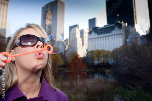 Young Woman Playing with Bubbles in Cental Park NYC